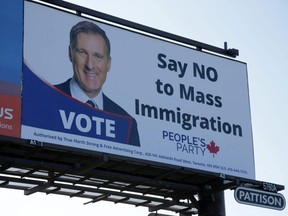 A billboard featuring the portrait of People’s Party of Canada leader Maxime Bernier and its message "Say NO to Mass Immigration" is displayed in Toronto, on Sunday, Aug. 25, 2019.