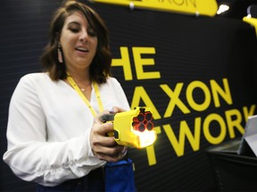 Allie Russo with Axon shows off the latest in Taser technology in the trade show at the Canadian Association of Chiefs of Police Conference at the Telus Convention Centre on Monday August 12, 2019.  Gavin Young/Postmedia