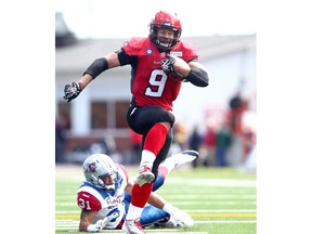 Calgary Stampeders Jon Cornish runs in a TD against the Montreal Alouettes in secind half action during the home opener at McMahon stadium in Calgary, Alta. on Saturday June 28, 2014. Darren Makowichuk/Calgary Sun/QMI Agency