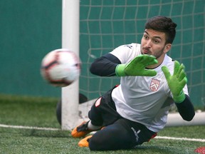Cavalry FC goalkeeper Marco Carducci stops the ball during a training session at Foothills Fieldhouse in Calgary on  Tuesday, March 26, 2019.