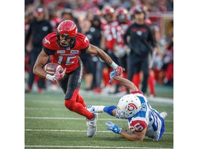 Calgary Stampeders Eric Rogers makes a catch in front of Greg Ducre Montreal Alouettes during CFL football in Calgary on Saturday, July 21, 2018. Al Charest/Postmedia