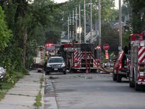 Explosion-rocked Woodman Avenue, site of Wednesday night's natural gas blast and fires in london, remained choked by fire trucks hours later Thursday morning, with about 20 firefighters still working the area. (SEBASTIAN BRON, The London Free Press)
