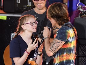 Singer/songwriter Keith Urban bring a fan onstage as he performs on ABC's "Good Morning America" at SummerStage at Rumsey Playfield, Central Park on August 9, 2019 in New York City. (Mike Coppola/Getty Images)