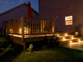 Wooden deck and patio of family home at night.