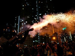Riot police fire tear gas to disperse anti-extradition bill protesters after a march to demand democracy and political reforms, at Wong Tai Sin, Hong Kong, China August 24, 2019.