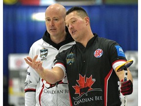 Skip Kevin Koe (left) discusses a shot with lead Ben Hebert (right) during game action against Team James Paul at the Alberta provincial men's curling championship held at the Ellerslie Curling Club in Edmonton on Thursday February 7, 2019.