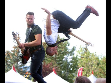 Guitarist Brock Hunter of the Hunter Brothers does a backflip over brother Luke on the second day of the Country Thunder music festival, held at Prairie Winds Park in Calgary Saturday, August 17, 2019. Dean Pilling/Postmedia