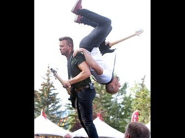 Guitarist Brock Hunter of the Hunter Brothers does a backflip over brother Luke on the second day of the Country Thunder music festival, held at Prairie Winds Park in Calgary Saturday, August 17, 2019. Dean Pilling/Postmedia