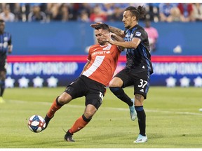 CP-Web.  Montreal Impact's Maximiliano Urruti, right, challenges Cavalry FC's Jonathan Wheeldon during first half semifinal Canadian Championship soccer action in Montreal, Wednesday, August 7, 2019.