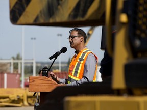 Minister of Natural Resources Amarjeet Sohi is framed by pipeline heavy machinery, as he speaks to reporters during a press conference at SA Energy Group, after it was announced that construction on the Trans Mountain Pipeline will restart within the month, in Edmonton Wednesday Aug. 21, 2019. Contractors, like SA Energy Group, now have 30 days to hire crews, get equipment in place, and develop detailed construction plans. Photo by David Bloom