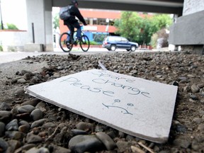 A "Spare Change Please" sign is seen in the old South Calgary Funeral Centre along 2nd St. and 17 Ave. S.W. near the Sheldon Chumir Health Centres safe injection site on Friday. Photo by Brendan Miller/Postmedia.