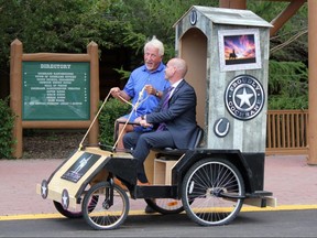 Great Cochrane Outhouse Race organizer Dan Kroffat (left) and Cochrane Mayor Jeff Genung put their potty through the paces. Patrick Gibson/Postmedia Calgary