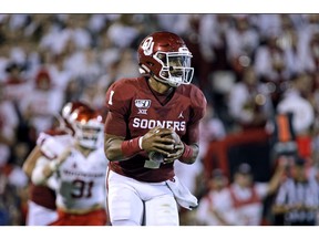Oklahoma Sooners quarterback Jalen Hurts runs in the backfield against the Houston Cougars at Gaylord Family Oklahoma Memorial Stadium on Sunday in Norman, Okla. The Sooners defeated the Cougars 49-31.