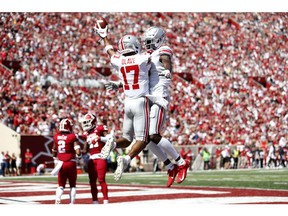 Chris Olave #17 and Binjimen Victor #9 of the Ohio State Buckeyes celebrate after a safety in the game against the Indiana Hoosiers at Memorial Stadium on September 14, 2019 in Bloomington, Indiana.