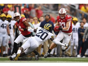 Garrett Groshek #37 of the Wisconsin Badgers is pursued by Brad Hawkins #20 of the Michigan Wolverines at Camp Randall Stadium on September 21, 2019 in Madison, Wisconsin.