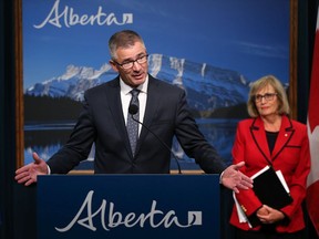 Alberta Finance Minister Travis Toews speaks on the report the province commissioned on the state of the Alberta'a finances at the McDougall Centre in Calgary on Tuesday September 3, 2019. Former Saskatchewan finance minister Janice MacKinnon who chaired the report listens in the background.