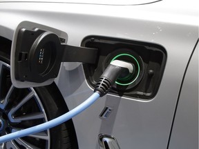 A BMW vehicle is being charged at the Paris Auto Show in Paris, France, Thursday, Sept. 29, 2016.