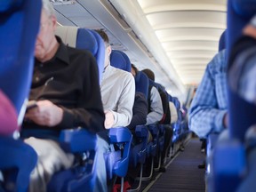 Aisle between the seats in the airplane cabin.