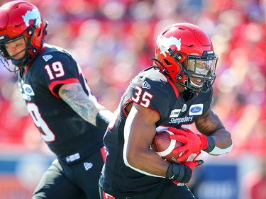 Calgary Stampeders quarterback hands off quarterback Bo Levi Mitchell to running back Ka'Deem Carey during CFL football against the Edmonton Eskimos in Calgary on Monday, September 2, 2019. Al Charest/Postmedia