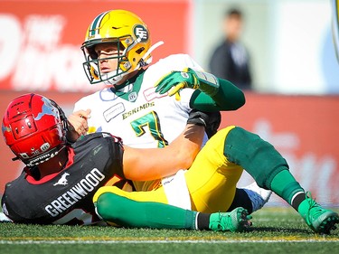 Edmonton Eskimos is is tackled by Cory Greenwood of the Calgary Stampeders during CFL football in Calgary on Monday, September 2, 2019. Al Charest/Postmedia