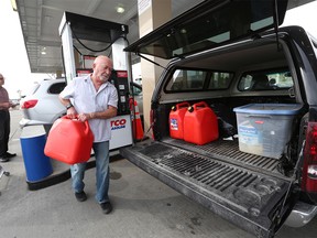 Joseph Columpsi filled up some jerry cans after filling up his truck at the Costco in Deerfoot Meadows on Monday morning September 16, 2019. Prices are expected to rise with the recent attack on oil facilities in Saudi Arabia. Gavin Young/Postmedia