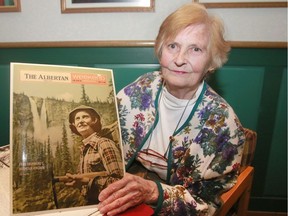 Fran Drummond, operator of the Twin Falls Chalet in Yoho National Park, looks through magazines and newspaper clippings of her life at the chalet.