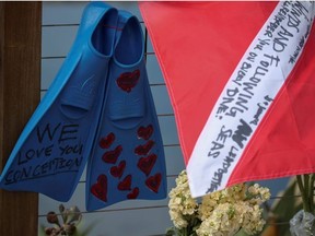 A diving flag and fins hang on a makeshift memorial near Truth Aquatics after a fire that sank a commercial diving boat off Santa Barbara, California, U.S., September 3, 2019.