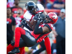 The Calgary Stampeders' Tre Roberson with his third interception of the game against the Ottawa Redblacks during CFL football in Calgary on Saturday. File photo by Al Charest/Postmedia.