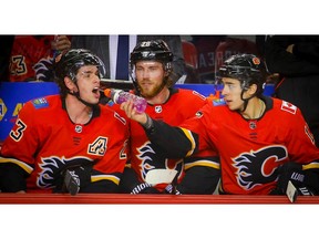 Calgary Flames Johnny Gaudreau celebrates with the purple Gatorade with teammates Sean Monahan and Elias Lindholm after scoring a power play against the San Jose Sharks in NHL hockey at the Scotiabank Saddledome in Calgary on Monday, December 31, 2018. Al Charest/Postmedia