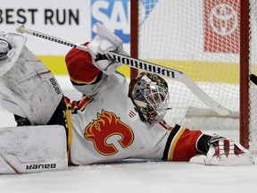 Calgary Flames goalie Cam Talbot stops a shot from the San Jose Sharks during NHL pre-season action on Sept. 26, 2019, in San Jose, Calif.