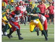 Sep 7, 2019; Edmonton, Alberta, Canada; Edmonton Eskimos quarterback Trevor Harris (7) is chased down by Calgary Stampeders defensive lineman Derek Wigan (97) during a Canadian Football League game at Commonwealth Stadium. Mandatory Credit: Perry Nelson-USA TODAY Sports ORG XMIT: USATSI-408206