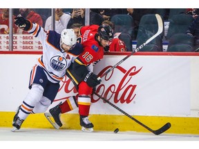 Flames right winger Tobias Rieder (right) battle for the puck with Oilers defenceman Adam Larsson and has himself a game last night at the Saddledome.  Sergei Belski/USA TODAY