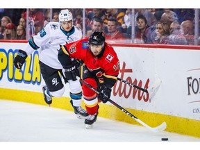 Sep 18, 2019; Calgary, Alberta, CAN; Calgary Flames right wing Tobias Rieder (16) and San Jose Sharks right wing Evan Wiederer (59) battle for the puck during the first period at Scotiabank Saddledome. Mandatory Credit: Sergei Belski-USA TODAY Sports ORG XMIT: USATSI-406631