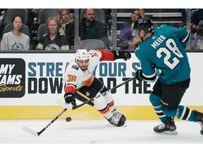 Sep 26, 2019; San Jose, CA, USA; Calgary Flames center Zac Rinaldo (36) reaches out for the puck against San Jose Sharks right wing Timo Meier (28) during the third period at the SAP Center at San Jose. Mandatory Credit: Stan Szeto-USA TODAY Sports ORG XMIT: USATSI-406687