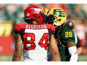 Edmonton Eskimos' Josh Johnson (26) and Calgary Stampeders' Reggie Begelton (84) face off during the first half of CFL football action at Commonwealth Stadium in Edmonton, on Saturday, Sept. 7, 2019. Photo by Ian Kucerak/Postmedia