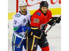 Calgary Flames Zac Rinaldo battles against Mitch Eliot of the Vancouver Canucks during pre-season NHL hockey in Calgary on Monday September 16, 2019. Al Charest / Postmedia