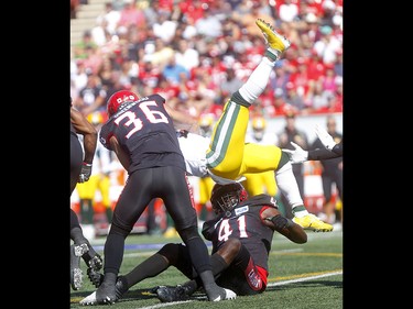 Calgary Stampeders, Cordarro Law tackles by Edminton Eskimos, Natey Adjei in first half action in the Labour Day classic at McMahon stadium in Calgary on Monday, September 2, 2019. Darren Makowichuk/Postmedia