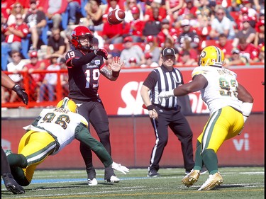 Calgary Stampeders, Bo Levi Mitchell with Edminton Eskimos, Mike Moore on him in first half action in the Labour Day classic at McMahon stadium in Calgary on Monday, September 2, 2019. Darren Makowichuk/Postmedia