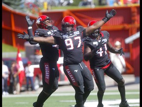 Calgary Stampeders defensive lineman Derek Wiggan sacks Edmonton Eskimos, Trevor Harris in first half action in the Labour Day classic at McMahon stadium in Calgary on Monday, September 2, 2019. Darren Makowichuk/Postmedia