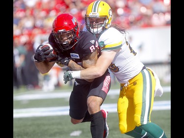 Calgary Stampeders, Reggie Begelton is tackled by a Edminton Eskimos, in first half action in the Labour Day classic at McMahon stadium in Calgary on Monday, September 2, 2019. Darren Makowichuk/Postmedia