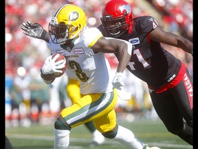 Calgary Stampeders, Cordarro Law stops Edmonton Eskimos, Natey Adjei in first half action in the Labour Day classic at McMahon stadium in Calgary on Monday, September 2, 2019. Darren Makowichuk/Postmedia