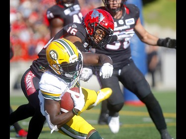 Calgary Stampeders, Royce Metchie stops Edmonton Eskimos, Natey Adjei in second half action in the Labour Day classic at McMahon stadium in Calgary on Monday, September 2, 2019. Darren Makowichuk/Postmedia