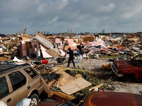 A man walks among debris at The Mud neighborhood, devastated after Hurricane Dorian hit the Abaco Islands in Marsh Harbour, Bahamas, Sept. 6, 2019.