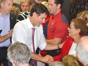 Prime Minister Justin Trudeau shakes hands with Verona Jackson at Bruce-Grey-Owen Sound Liberal candidate Michael Den Tandt's campaign office on Wednesday, September 4, 2019 in Owen Sound, Ont.