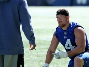 Adam Bighill speaks with defensive co-ordinator Richie Hall during Winnipeg Blue Bombers practice at IG Field on Tuesday.