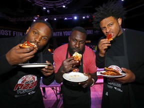 Calgary Stampeders L-R, Junior Turner, Cordarro Law and Mike Rose  during the Eric Francis Pizza Pigout,  an event where Calgary's finest celebrities, hundreds of hungry pizza lovers & foodies will come together to taste over 600 pizzas donated by local pizzerias. The night is filled with carbs, beer and general mayhem – a good time is had by all while raising money for KidSport Calgary and their partner charities in Calgary on Wednesday, October 16, 2019. Darren Makowichuk/Postmedia