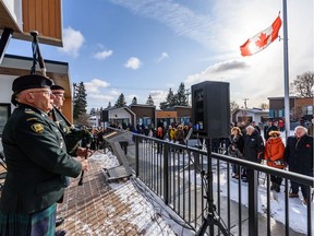 Bagpipers perform during a ceremony to honour Canadian veterans at 908 ATCO Village, a tiny home community for veterans experiencing homelessness.