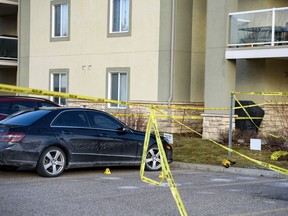Police are investigating the scene of a shooting in the parking lot of an apartment complex in the 2500 block of Fish Creek Boulevard on Wednesday, October 30, 2019. Azin Ghaffari/Postmedia Calgary