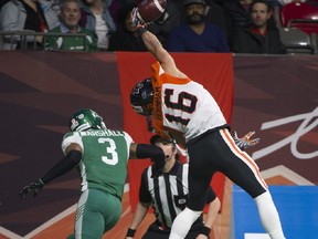 B.C. Lions receiver Bryan Burnham hauls in a pass despite pressure from the Saskatchewan Roughriders' Nick Marshall during CFL action at BC Place, in Vancouver on Oct. 18.  The catch was ruled incomplete, out of bounds. File photo by Gerry Kahrmann/Postmedia.