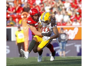 Calgary Stampeders Cory Greenwood tackles Edmonton Eskimos Tevaun Smith in second half CFL action at McMahon stadium in Calgary on Saturday, August 3, 2019. Darren Makowichuk/Postmedia